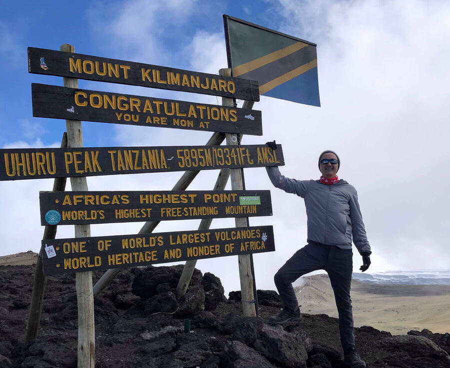 Brandon Bedford at the peak of Mount Kilimanjaro